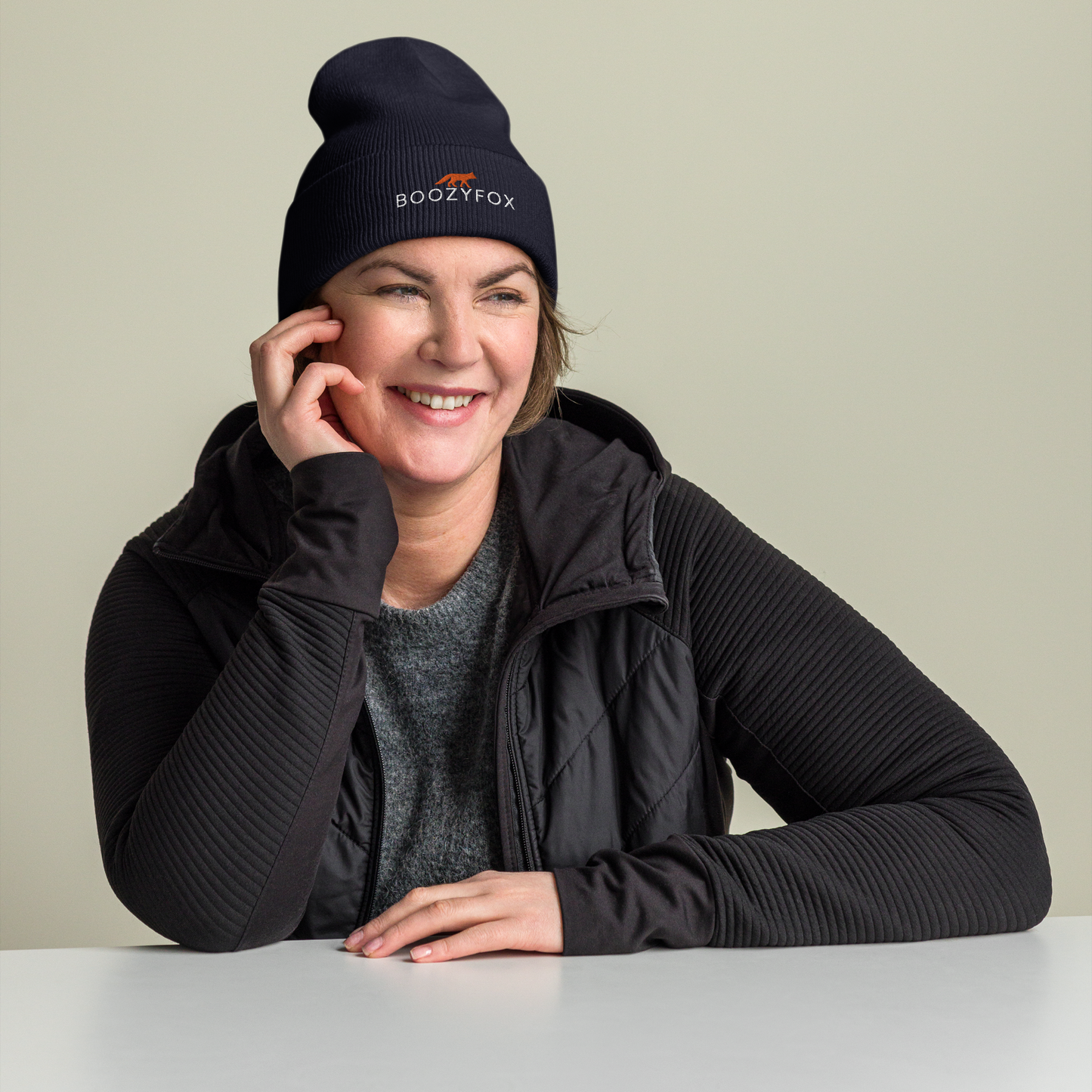 Smiling woman wearing a Navy Cuffed Beanie With An Embroidered Boozy Fox Logo On Fold - Shop Cuffed Beanie Online - Boozy Fox