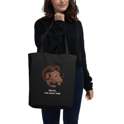 Woman carrying a Black Goat Eco Tote Bag featuring a fierce Relax I've Goat This graphic - Shop Tote Bags Online - Boozy Fox