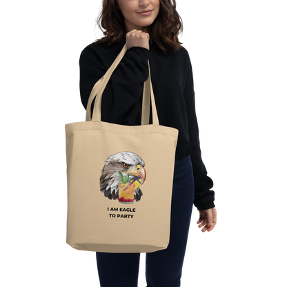 Woman carrying a Oyster Colored Eagle Eco Tote Bag featuring a captivating I Am Eagle To Party graphic - Funny Organic Cotton Totes - Boozy Fox