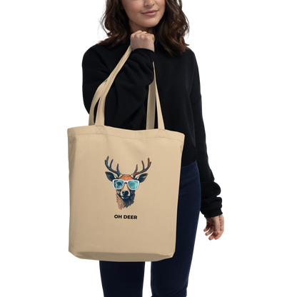 Woman carrying a Oyster Colored Deer Eco Tote Bag featuring a hilarious Oh Deer graphic - Shop Tote Bags Online - Boozy Fox