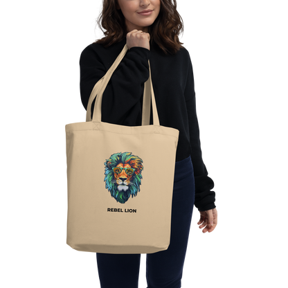 Woman carrying a Oyster Colored Lion Eco Tote Bag featuring a fierce Rebel Lion graphic - Shop Tote Bags Online - Boozy Fox