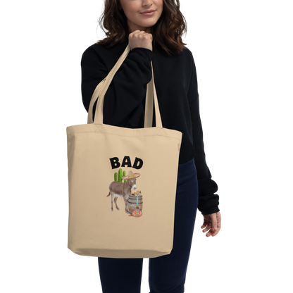 Woman carrying a Oyster Colored Donkey Eco Tote Bag Featuring a Funny Bad Ass Donkey Graphic - Shop Funny Organic Cotton Tote Bags Online - Boozy Fox