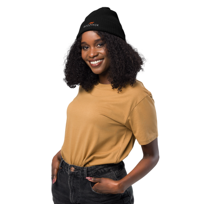 Smiling woman wearing a Black Organic Ribbed Beanie With An Embroidered Boozy Fox Logo On Fold - Shop Organic Cotton Beanies Online - Boozy Fox