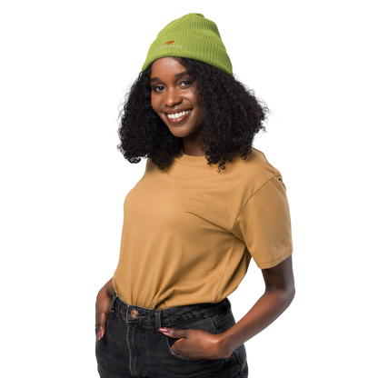 Smiling woman wearing a Leaf Green Organic Ribbed Beanie With An Embroidered Boozy Fox Logo On Fold - Shop Organic Cotton Beanies Online - Boozy Fox