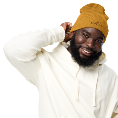 Smiling man wearing a Mustard Yellow Organic Ribbed Beanie With An Embroidered Boozy Fox Logo On Fold - Shop Organic Cotton Beanies Online - Boozy Fox