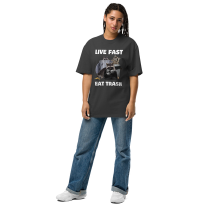 Woman wearing a Faded Black Raccoon Oversized T-Shirt featuring the bold Live Fast Eat Trash graphic on the chest - Funny Graphic Raccoon Oversized Tees - Boozy Fox
