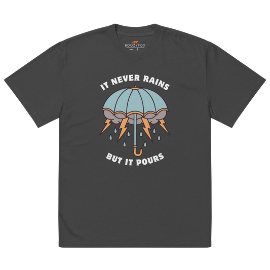 Faded Black Umbrella Oversized T-Shirt featuring a bold It Never Rains But It Pours graphic on the chest - Cool Tattoo-Inspired Graphic Umbrella Oversized Tees - Boozy Fox