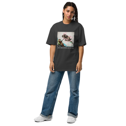 Woman wearing a Faded Black The Creation of Otter Oversized Tee - Boozy Fox