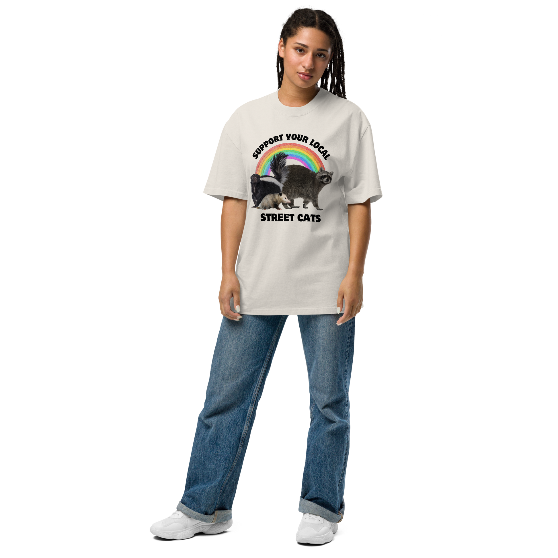 Woman wearing a Faded Bone Street Cats Oversized T-Shirt featuring a purr-fect trio – opossum, skunk, raccoon – and the Support Your Local Street Cats graphic on the chest - Funny Graphic Animal Oversized Tees - Boozy Fox