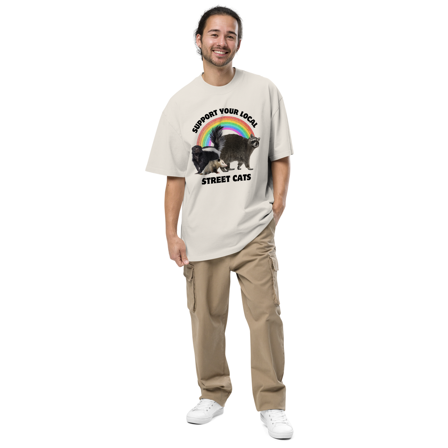 Smiling man wearing a Faded Bone Street Cats Oversized T-Shirt featuring a purr-fect trio – opossum, skunk, raccoon – and the Support Your Local Street Cats graphic on the chest - Funny Graphic Animal Oversized Tees - Boozy Fox