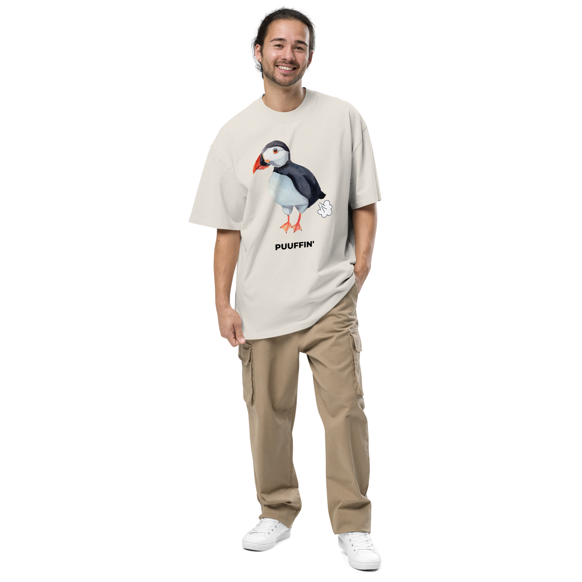 Smiling man wearing a Faded Bone Puffin Oversized T-Shirt featuring a comic Puuffin' graphic on the chest - Funny Graphic Puffin Oversized Tees - Boozy Fox
