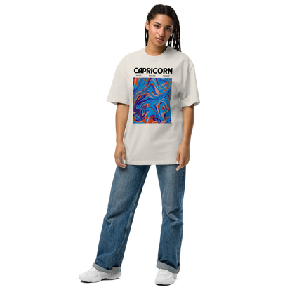Woman wearing a Faded Bone Capricorn Oversized T-Shirt featuring an Abstract Capricorn Star Sign graphic on the chest - Cool Graphic Zodiac Oversized Tees - Boozy Fox