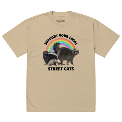 Faded Khaki Street Cats Oversized T-Shirt featuring a purr-fect trio – opossum, skunk, raccoon – and the Support Your Local Street Cats graphic on the chest - Funny Graphic Animal Oversized Tees - Boozy Fox