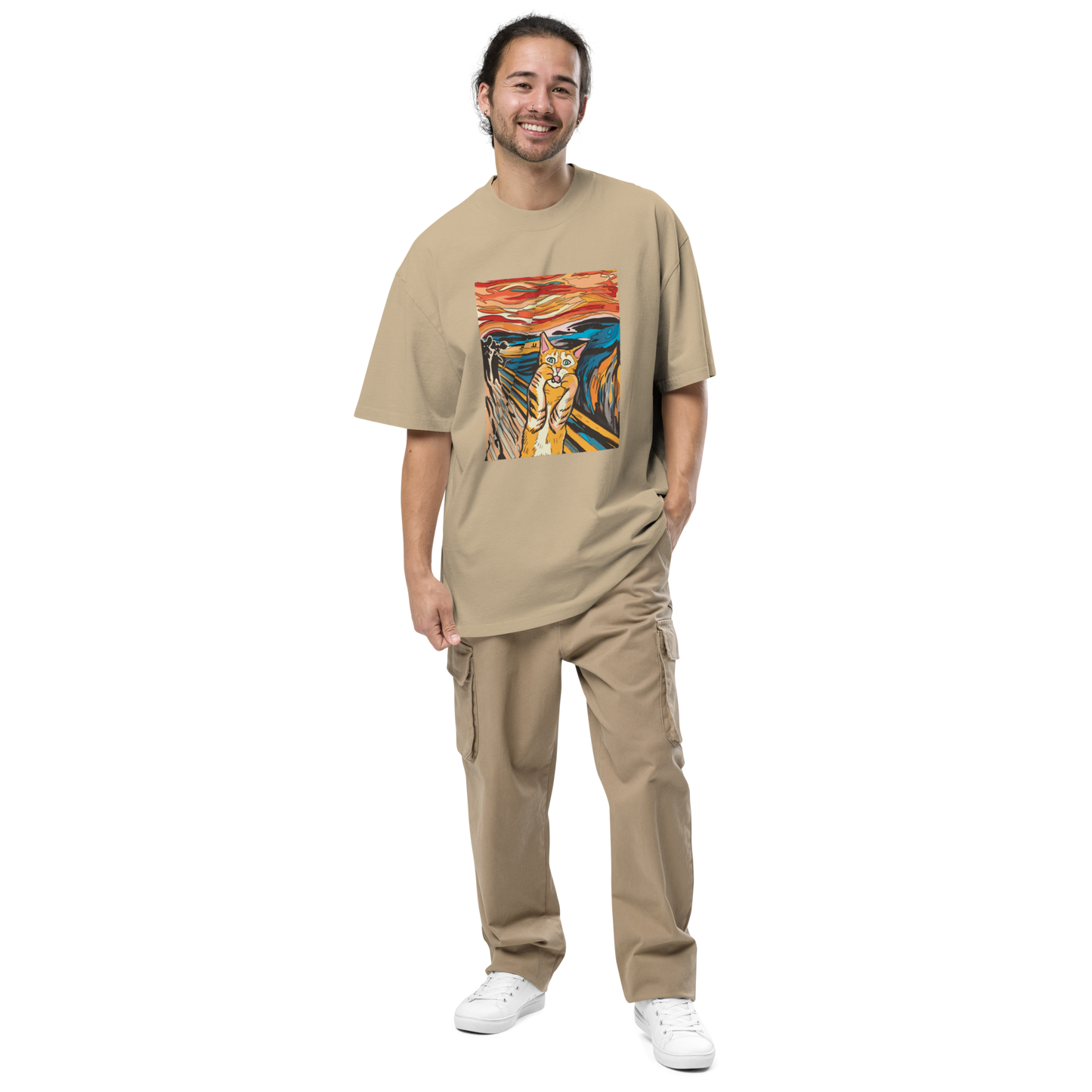 Smiling man wearing a Faded Khaki Screaming Cat Oversized T-Shirt showcasing the iconic 'The Scream' graphic on the chest - Funny Graphic Cat Oversized Tees - Boozy Fox