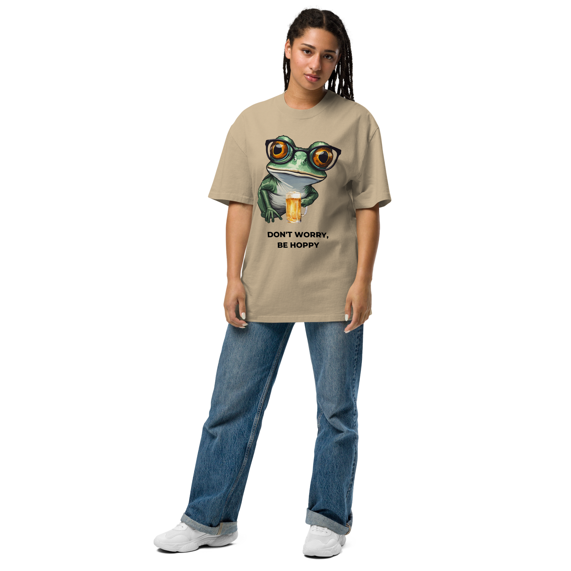 Woman wearing a Faded Khaki Frog Oversized T-Shirt featuring a ribbitting Don't Worry, Be Hoppy graphic on the chest - Funny Graphic Frog Oversized Tees - Boozy Fox