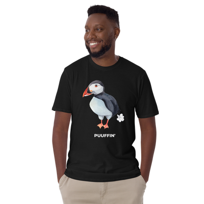 Smiling man wearing a Black Puffin T-Shirt featuring a comic Puuffin' graphic on the chest - Funny Graphic Puffin T-Shirts - Boozy Fox