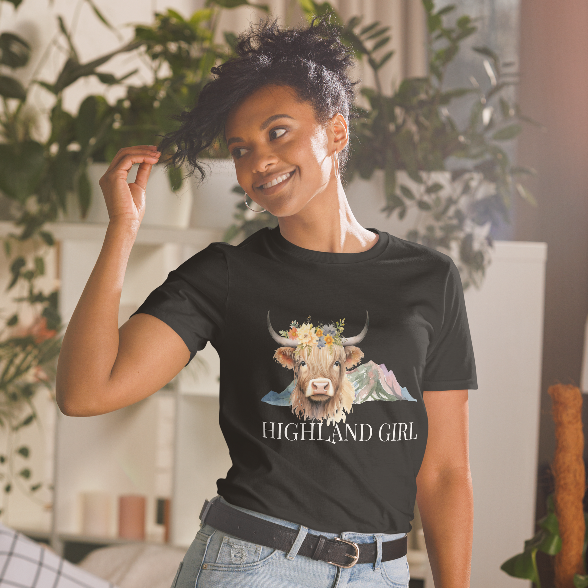 Smiling woman wearing a Black Highland Cow T-Shirt featuring an adorable Highland Girl graphic on the chest - Cute Graphic Highland Cow T-Shirts - Boozy Fox