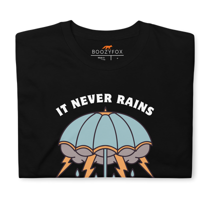 Front details of a Black Umbrella T-Shirt featuring a unique It Never Rains But It Pours graphic on the chest - Cool Tattoo-Inspired Graphic Umbrella T-Shirts - Boozy Fox