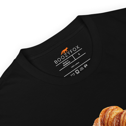 Product details of a Funny Le Croissant graphic t-shirt in black by Boozy Fox