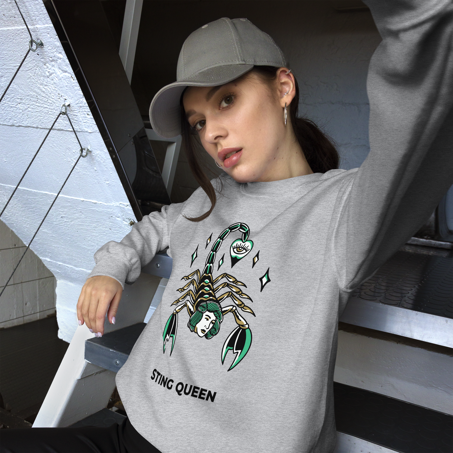 Woman wearing a Sport Grey Scorpion Sweatshirt featuring the Sting Queen graphic on the chest - Cool Graphic Scorpion Sweatshirts - Boozy Fox