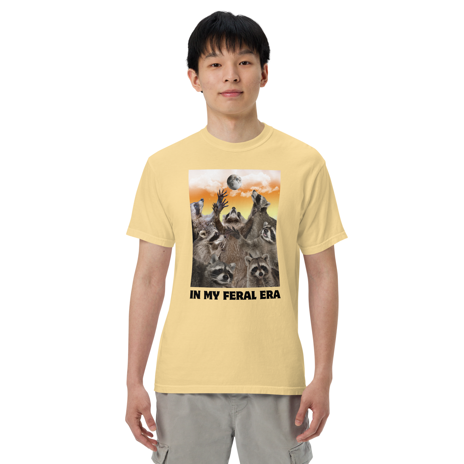 Man wearing a Funny In My Feral Era Raccoon heavyweight graphic t-shirt in butter yellow by Boozy Fox