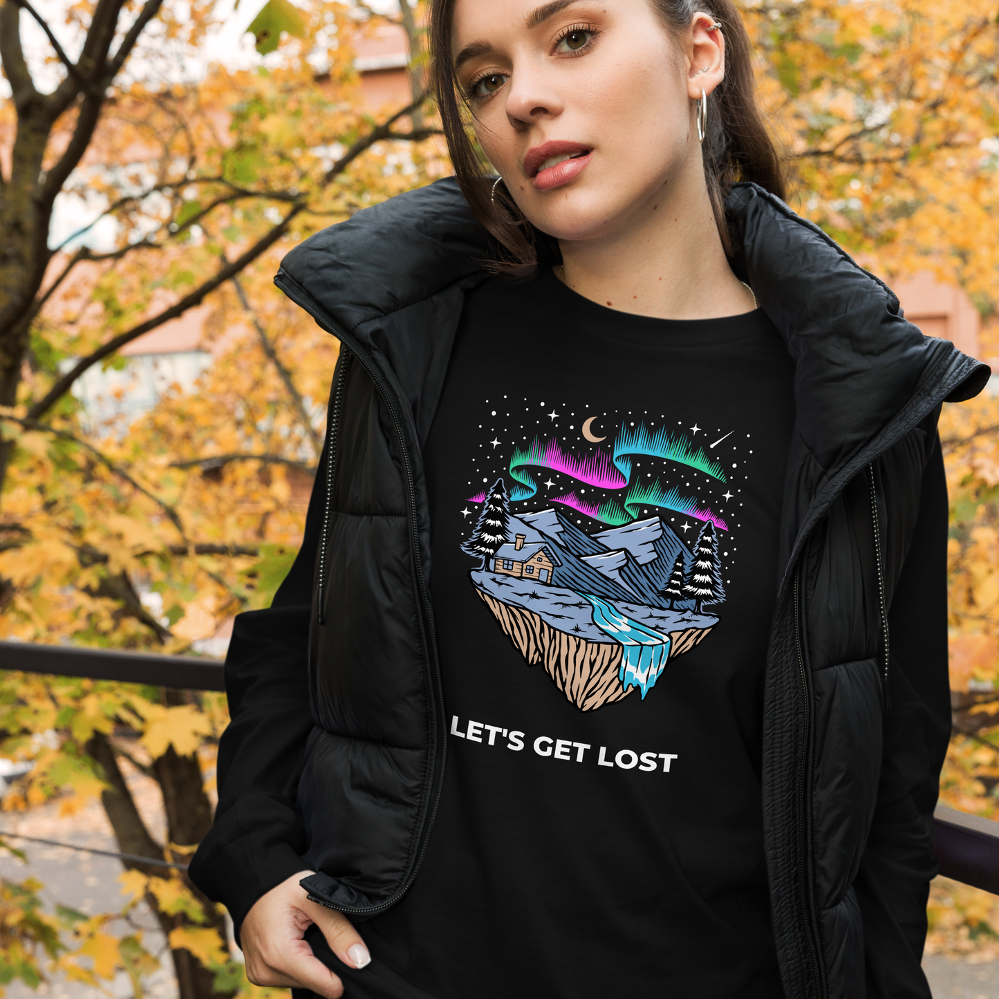 Woman wearing a Black Let's Get Lost Long Sleeve Tee featuring a mesmerizing night sky, adorned with stars and aurora borealis graphic on the chest - Cool Northern Lights Long Sleeve Graphic Tees - Boozy Fox