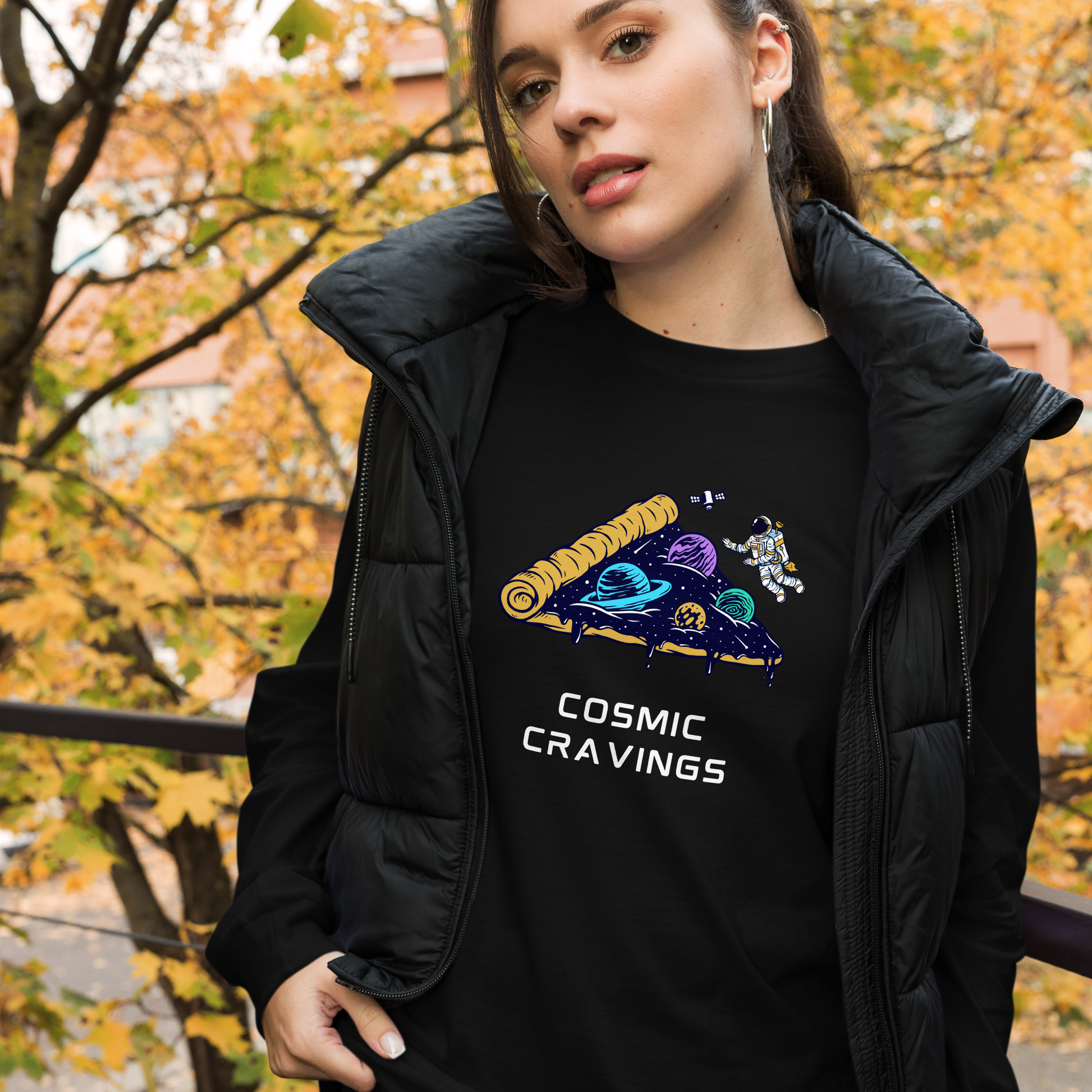 Woman wearing a Black Cosmic Cravings Long Sleeve Tee featuring an Astronaut Exploring a Pizza Universe graphic on the chest - Funny Space Long Sleeve Graphic Tees - Boozy Fox
