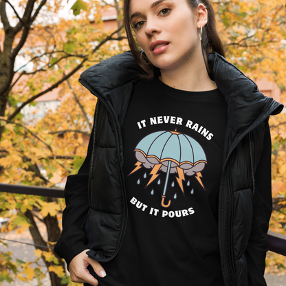 Woman wearing a Black Umbrella Long Sleeve Tee featuring a unique It Never Rains But It Pours graphic on the chest - Cool Tattoo-Inspired Umbrella Long Sleeve Graphic Tees - Boozy Fox