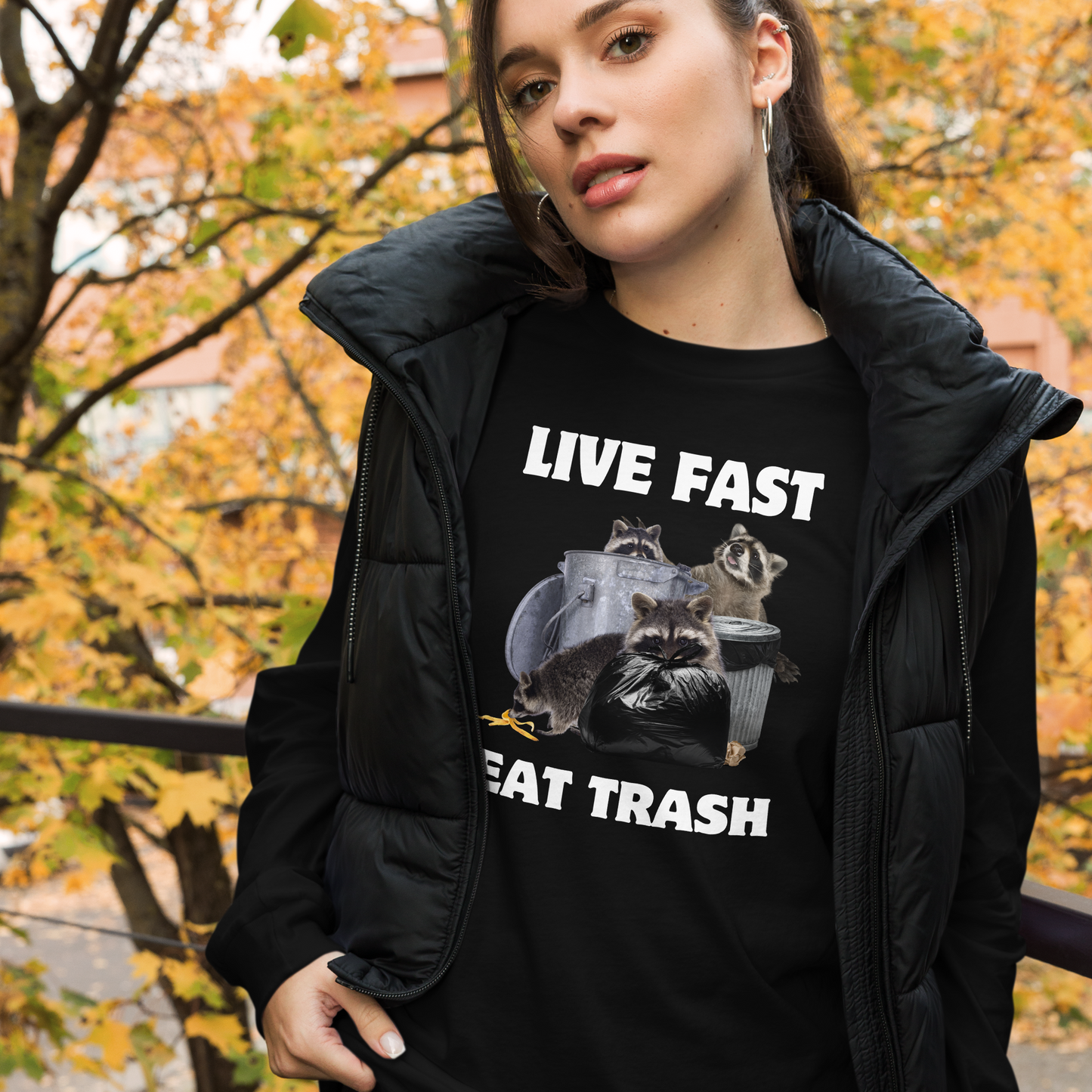 Woman wearing a Black Raccoon Long Sleeve Tee featuring a funny Live Fast Eat Trash graphic on the chest - Funny Raccoon Long Sleeve Graphic Tees - Boozy Fox