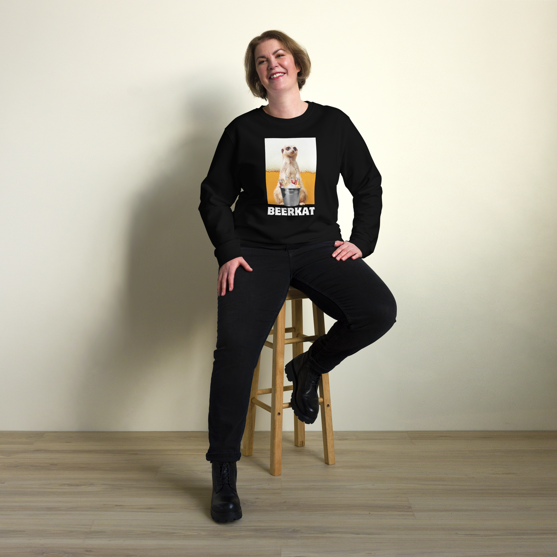 Smiling woman wearing a Black Meerkat Organic Cotton Sweatshirt - Boozy Fox