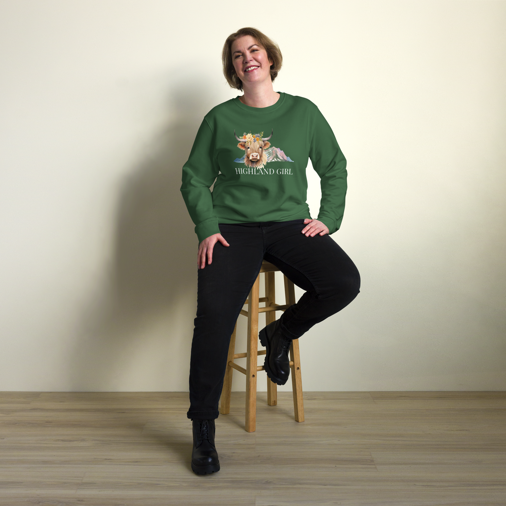 Smiling woman wearing a Bottle Green Organic Cotton Highland Cow Sweatshirt showcasing an adorable Highland Girl graphic on the chest - Cute Graphic Highland Cow Sweatshirts - Boozy Fox