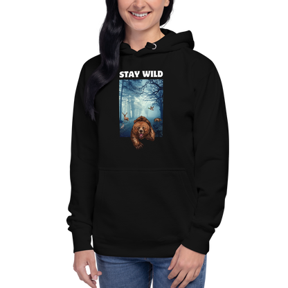 Woman wearing a Black Premium Bear Hoodie featuring a Stay Wild graphic on the chest - Cool Graphic Bear Hoodies - Boozy Fox