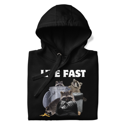 Front details of a funny Live Fast Eat Trash Raccoon premium graphic hoodie in black by Boozy Fox