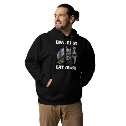 Man wearing a funny Live Fast Eat Trash Raccoon premium graphic hoodie in black by Boozy Fox