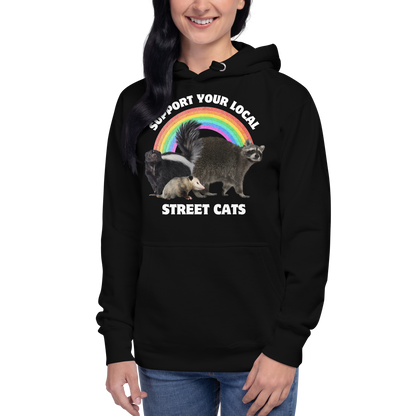 Woman wearing a Funny Support Your Local Street Cats premium graphic hoodie in black by Boozy Fox