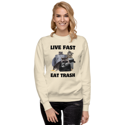 Smiling woman wearing a bone Live Fast, Eat Trash Raccoon Graphic Premium Sweatshirt - Boozy Fox