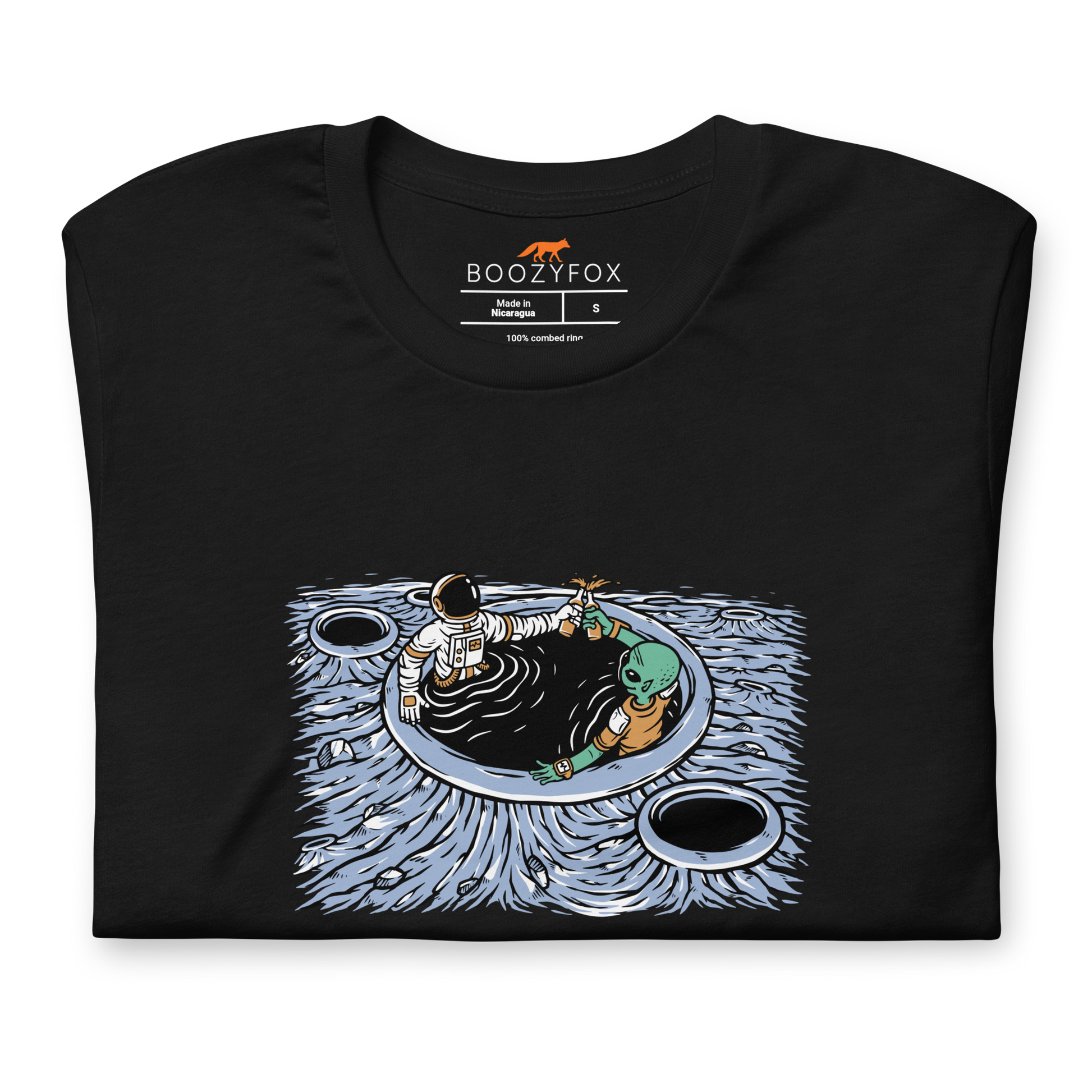 Front details of a Black Premium Galactic Hangs Tee featuring an out-of-this-world graphic of an Astronaut and Alien Chilling Together - Funny Graphic Space Tees - Boozy Fox