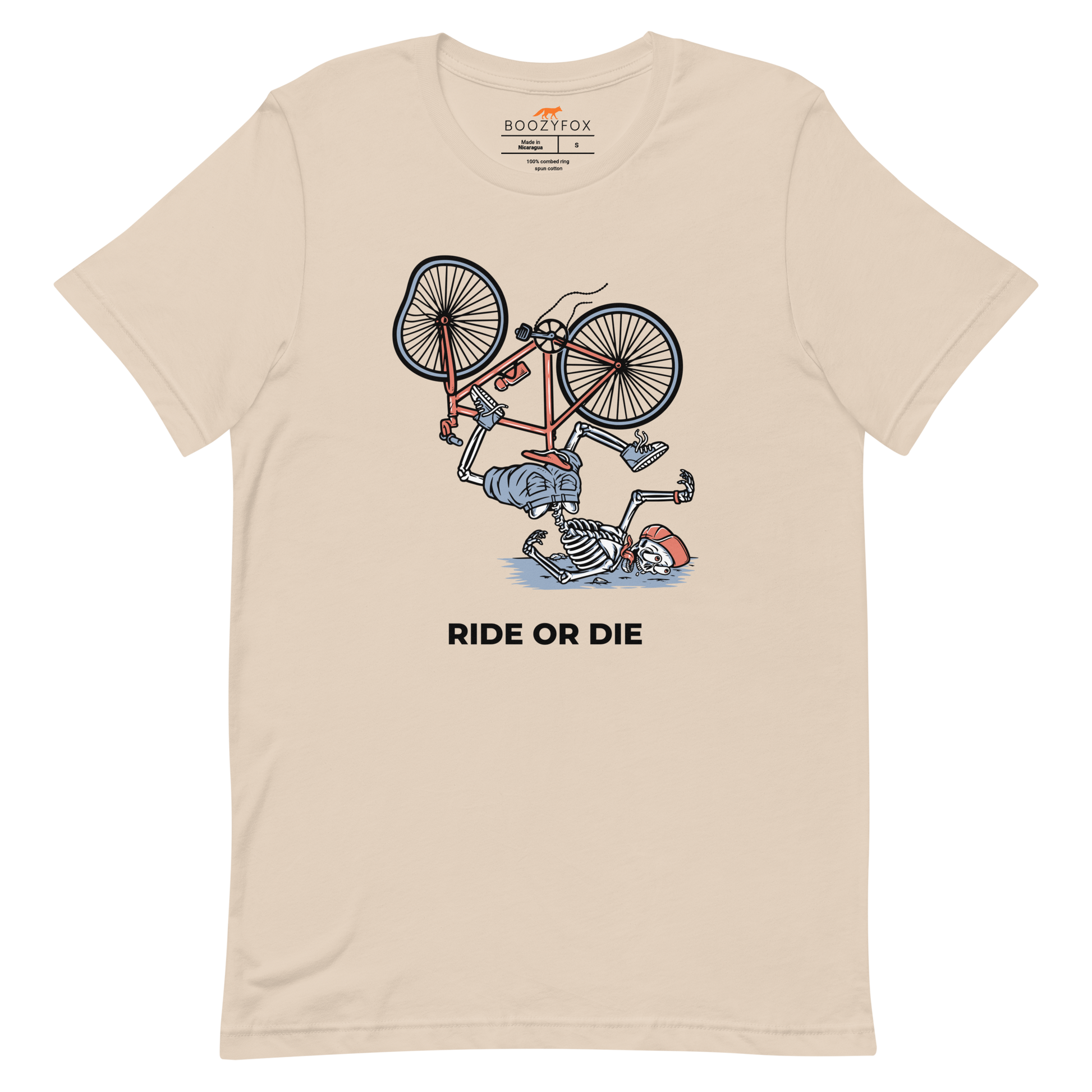 Soft Cream Premium Ride or Die Tee featuring a bold Skeleton Falling While Riding a Bicycle graphic on the chest - Funny Graphic Skeleton Tees - Boozy Fox