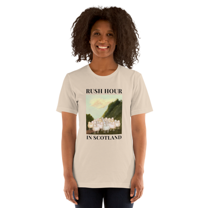 Woman wearing a Soft Cream Premium Sheep T-Shirt featuring a comical Rush Hour In Scotland graphic on the chest - Artsy/Funny Graphic Sheep Tees - Boozy Fox