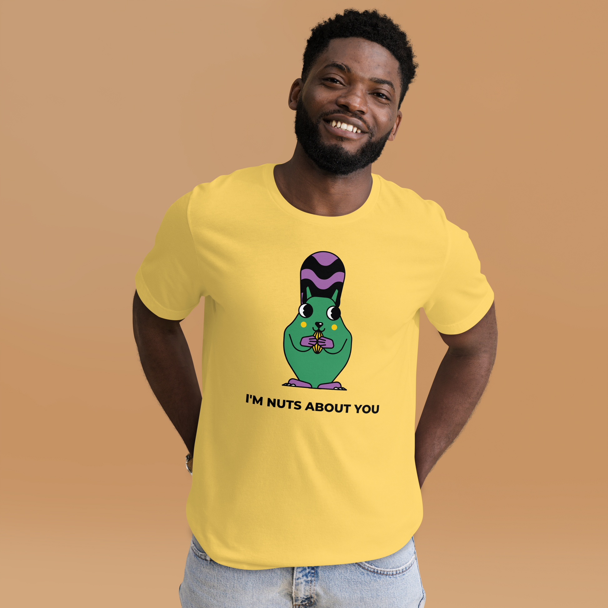 Smiling man wearing a Yellow Premium Squirrel T-Shirt featuring an I'm Nuts About You graphic on the chest - Funny Graphic Squirrel Tees - Boozy Fox