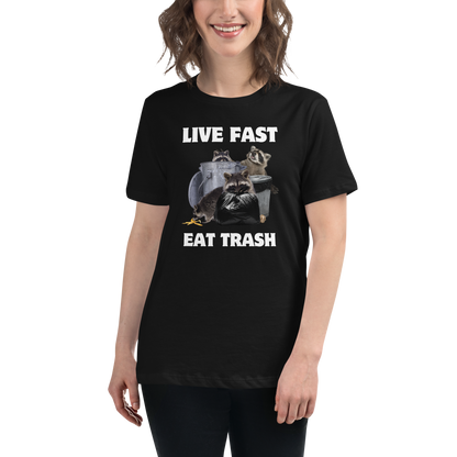 Smiling woman wearing a Women's Black Raccoon T-Shirt featuring a hilarious Live Fast Eat Trash graphic on the chest - Women's Funny Graphic Raccoon Tees - Boozy Fox