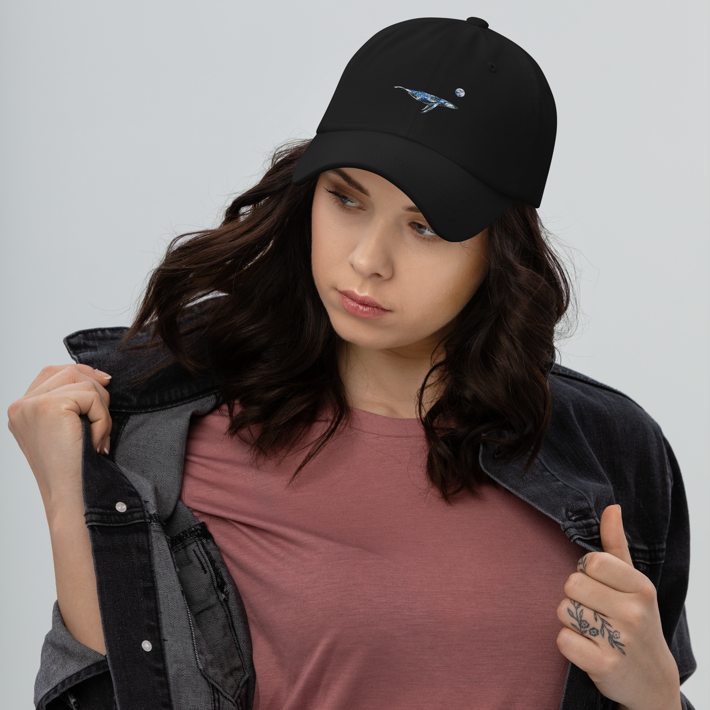 Woman Wearing a Cool black whale dad hat featuring a majestic Whale Under The Moon embroidery on Front. Shop Cool Dad Hats Online - Boozy Fox