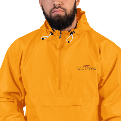 Man Wearing a Gold Champion Packable Jacket featuring a sleek embroidered Boozy Fox logo on the chest - Waterproof Champion Windbreakers & Raincoats - Boozy Fox