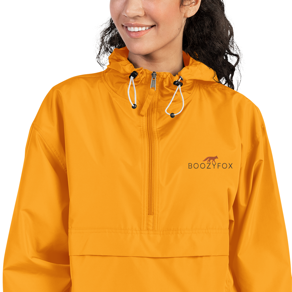 Smiling Woman Wearing a Gold Champion Packable Jacket featuring a sleek embroidered Boozy Fox logo on the chest - Waterproof Champion Windbreakers & Raincoats - Boozy Fox
