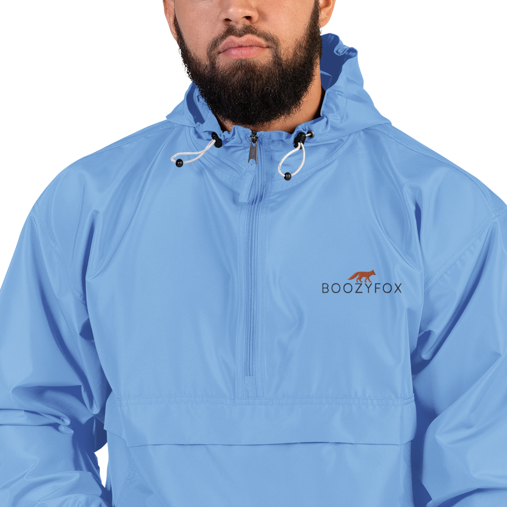 Man Wearing a Light Blue Champion Packable Jacket featuring a sleek embroidered Boozy Fox logo on the chest - Waterproof Champion Windbreakers & Raincoats - Boozy Fox
