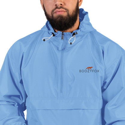 Man Wearing a Light Blue Champion Packable Jacket featuring a sleek embroidered Boozy Fox logo on the chest - Waterproof Champion Windbreakers & Raincoats - Boozy Fox