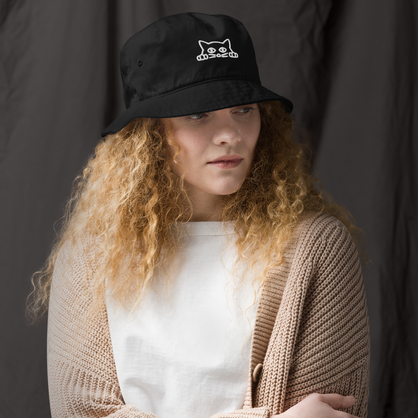 Woman wearing a Black Organic Bucket Hat featuring a funny Peeking Cat embroidery on the front - Bucket Hats - Boozy Fox