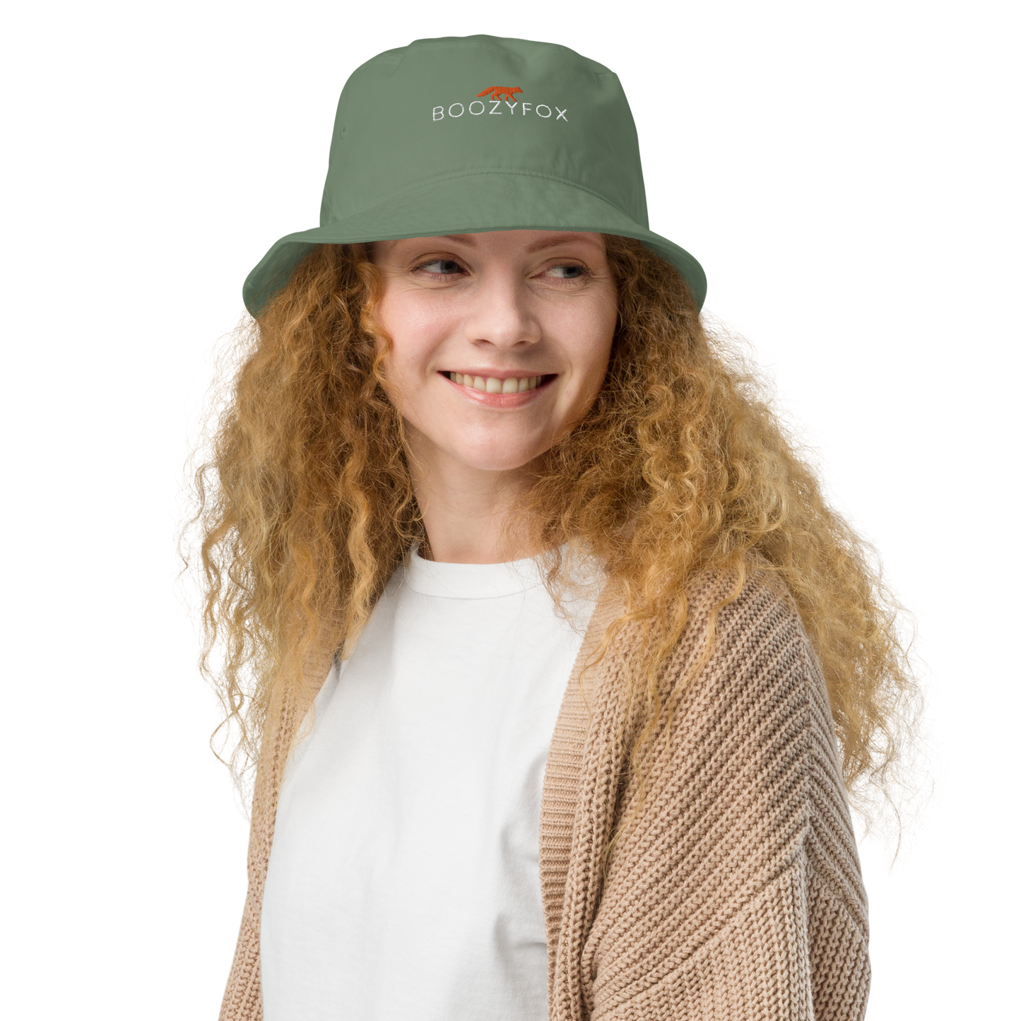 Smiling woman wearing a Dill Green Organic Bucket Hat featuring a recognizable Boozy Fox embroidery logo on the front - Bucket Hats - Boozy Fox